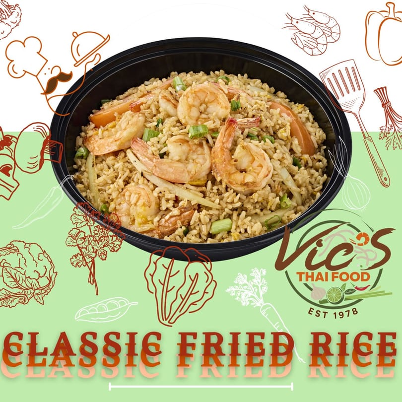 Classic fried rice with shrimp and green onions in a black bowl, from Vic's Thai Food.