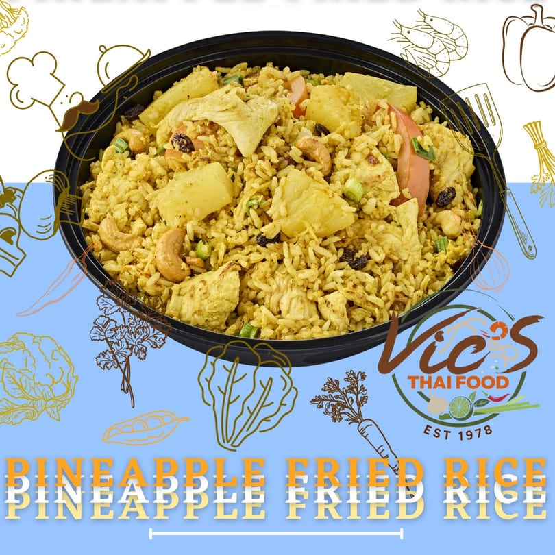 Vic's Thai Food pineapple fried rice with chicken, cashews, and raisins in a black bowl.
